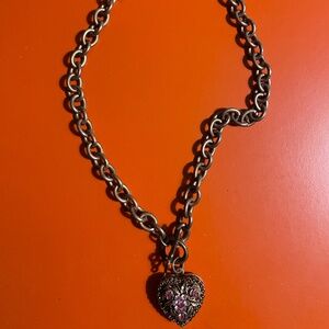 Unmarked bronze coloured heart locket necklace.